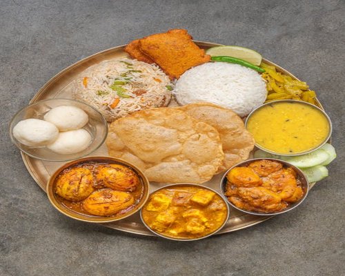 Traditional Bengali meal with rice, lentils, and vegetables