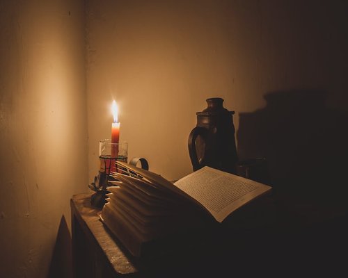 A quiet evening setting with a book and dim light